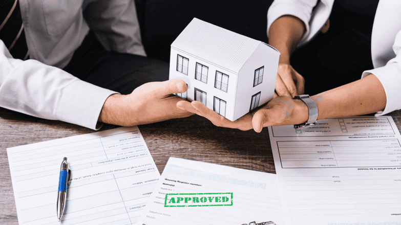 Hands exchanging house model during fast Chicago home sale process